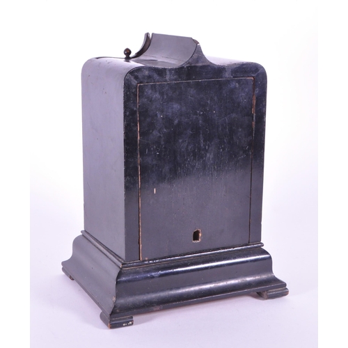 248 - An early 20th century French ebonized wooden mantel clock. The clock raised on block feet, with a st... 