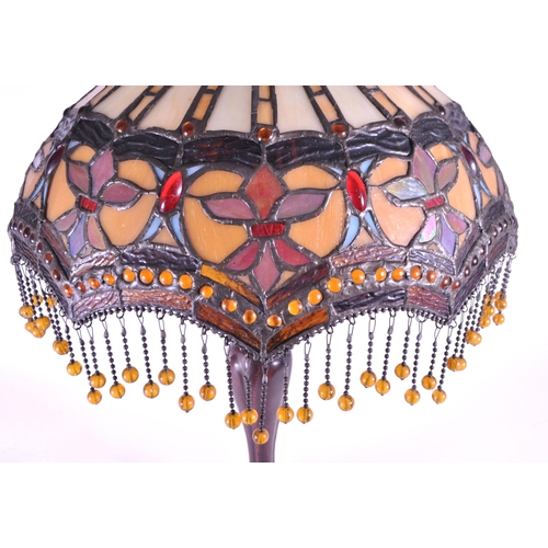 250 - 20th century Tiffany style table lamp featuring an oval glass shade. The lamp featuring a plinth sty... 