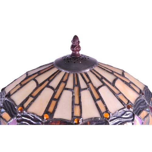 250 - 20th century Tiffany style table lamp featuring an oval glass shade. The lamp featuring a plinth sty... 