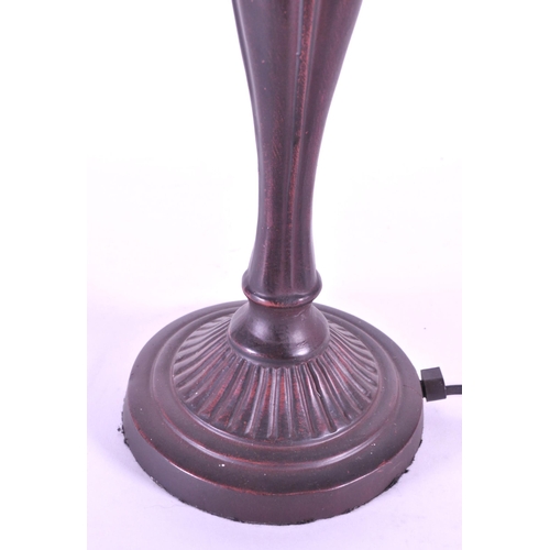 250 - 20th century Tiffany style table lamp featuring an oval glass shade. The lamp featuring a plinth sty... 