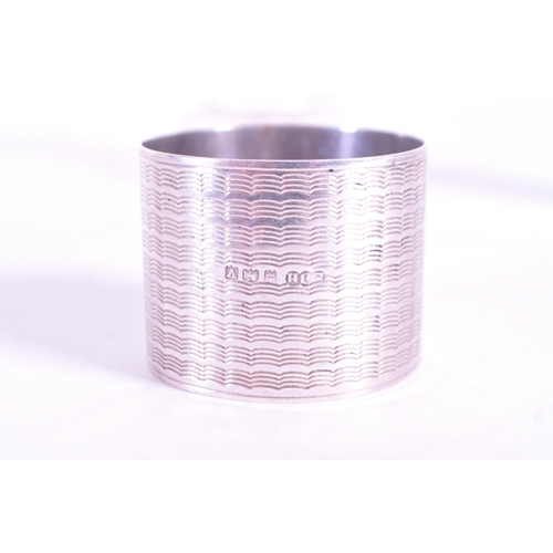 255 - Collection of early 20th century hallmarked silver pieces, comprised of a napkin ring, chain clutch ... 