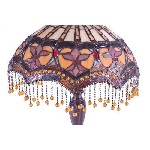 256 - A 20th century Tiffany style table lamp. The lamp featuring a plinth style base with fluted gadroone... 