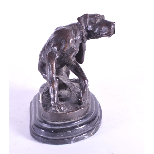 259 - After Christopher Fratin - A 20th century cast bronze hound figure. The dog sat scratching upon a na... 