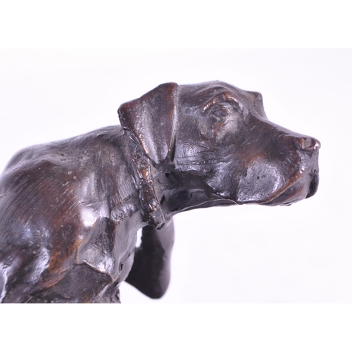 259 - After Christopher Fratin - A 20th century cast bronze hound figure. The dog sat scratching upon a na... 