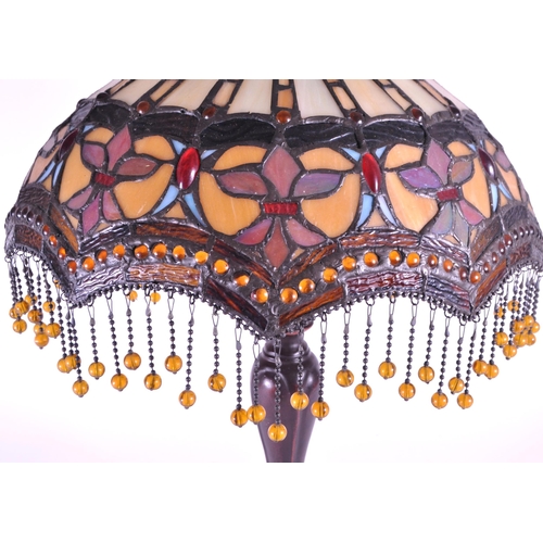 260 - A 20th century Tiffany style table lamp. The lamp featuring a plinth style base with fluted gadroone... 