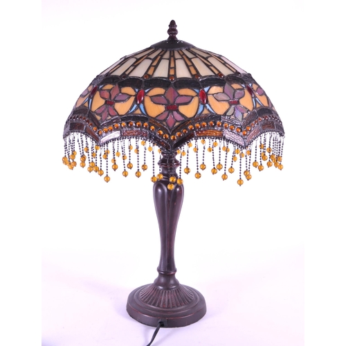 260 - A 20th century Tiffany style table lamp. The lamp featuring a plinth style base with fluted gadroone... 