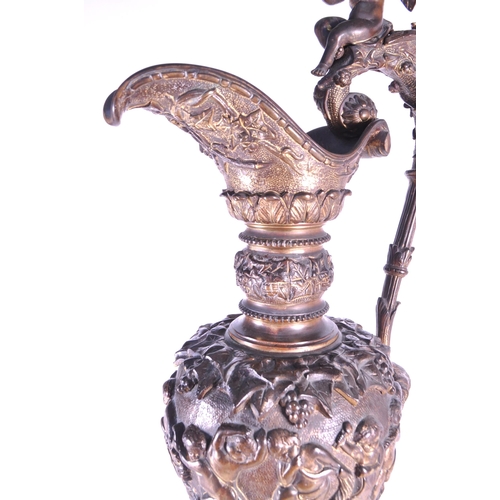 263 - A large 19th century French ormolu and bronze type ewer, the scroll handle surmounted by a cherub an... 