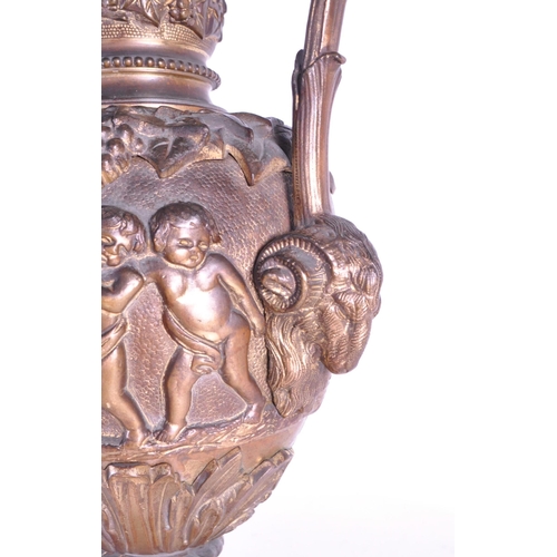 263 - A large 19th century French ormolu and bronze type ewer, the scroll handle surmounted by a cherub an... 