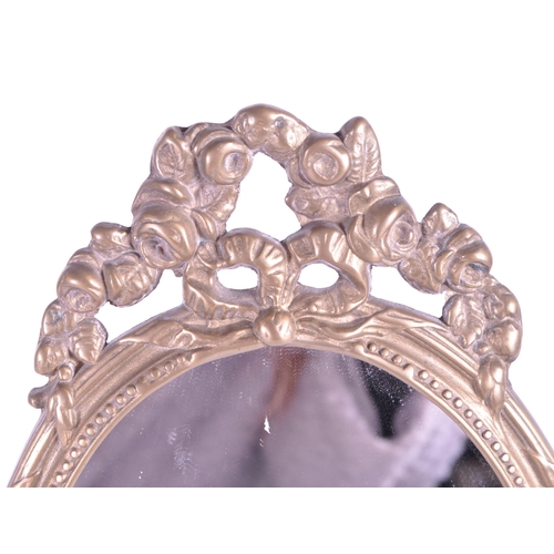 264 - A vintage 20th century gilt tabletop swing mirror. Neoclassical French style on scrolled foliate tre... 