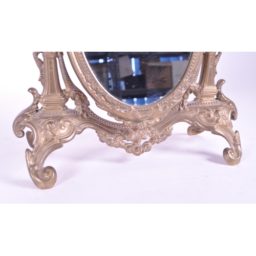 264 - A vintage 20th century gilt tabletop swing mirror. Neoclassical French style on scrolled foliate tre... 