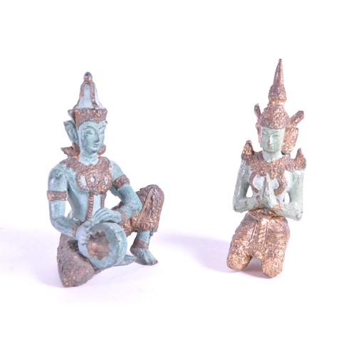 265 - Two 20th century bronze Thai Buddha temple figures. In traditional clothing with one playing drum th... 