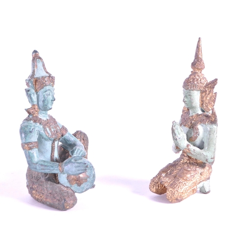 265 - Two 20th century bronze Thai Buddha temple figures. In traditional clothing with one playing drum th... 
