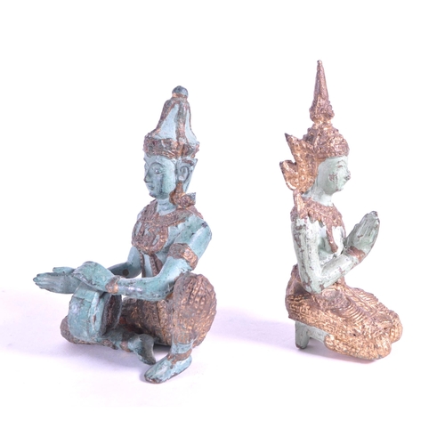 265 - Two 20th century bronze Thai Buddha temple figures. In traditional clothing with one playing drum th... 