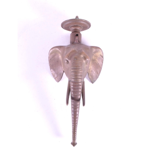 267 - A vintage 20th century brass door knocker in African elephant form. With long trunk, tusks and circu... 