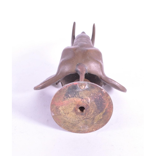 267 - A vintage 20th century brass door knocker in African elephant form. With long trunk, tusks and circu... 