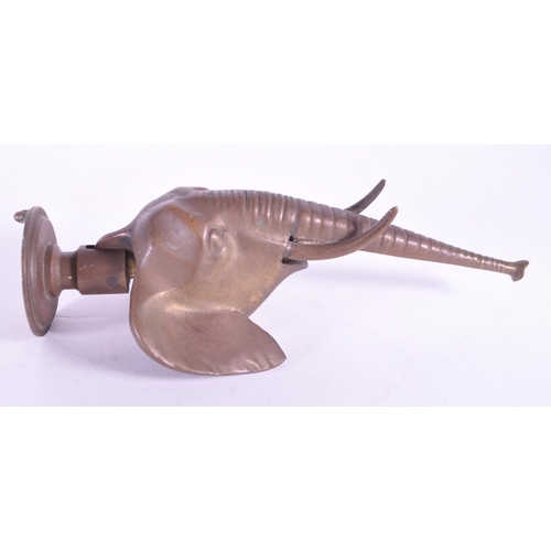 267 - A vintage 20th century brass door knocker in African elephant form. With long trunk, tusks and circu... 