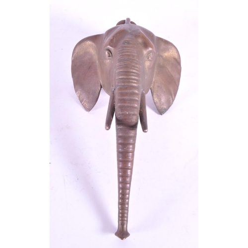 267 - A vintage 20th century brass door knocker in African elephant form. With long trunk, tusks and circu... 