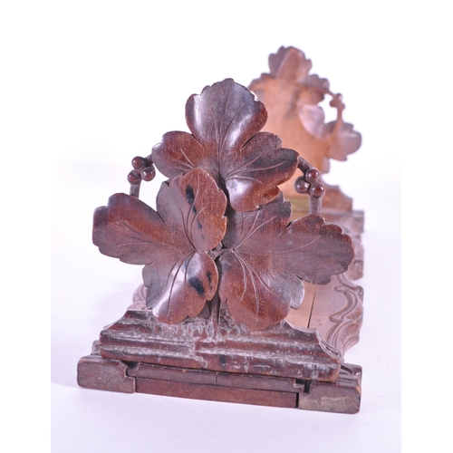 268 - A late 19th century black forest German adjustable book slide. With carved leaves to ends, adjustabl... 