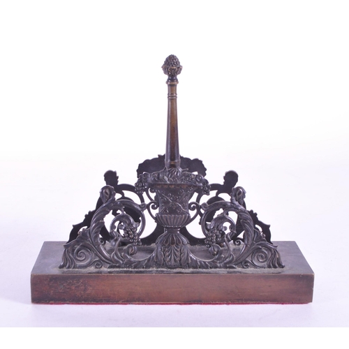 270 - A 19th century bronze letter magazine rack / desk tidy. Neoclassical design with acorn finial to cen... 