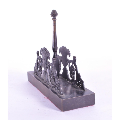 270 - A 19th century bronze letter magazine rack / desk tidy. Neoclassical design with acorn finial to cen... 