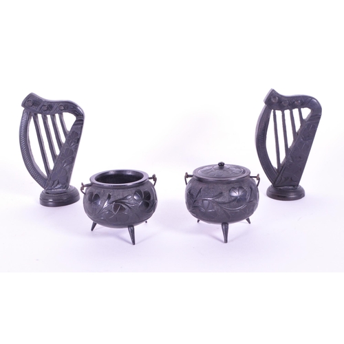 278 - Collection of four 20th century Irish carved ebony bog oak figures comprised of two cauldrons and tw... 