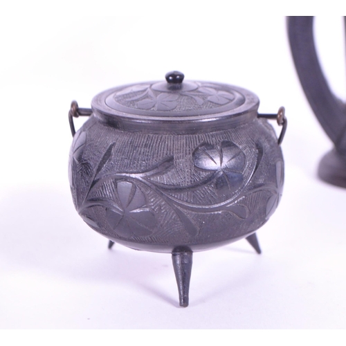 278 - Collection of four 20th century Irish carved ebony bog oak figures comprised of two cauldrons and tw... 