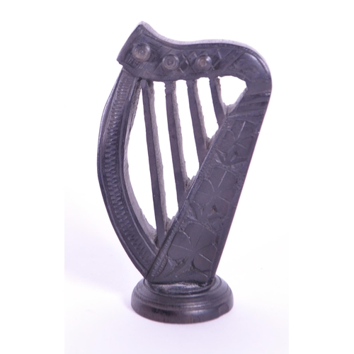 278 - Collection of four 20th century Irish carved ebony bog oak figures comprised of two cauldrons and tw... 