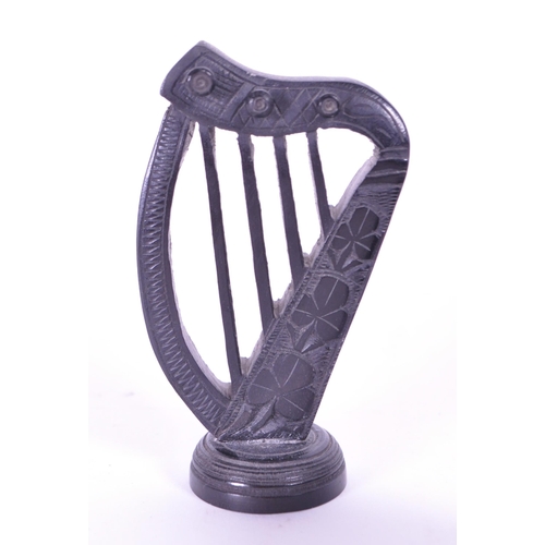 278 - Collection of four 20th century Irish carved ebony bog oak figures comprised of two cauldrons and tw... 