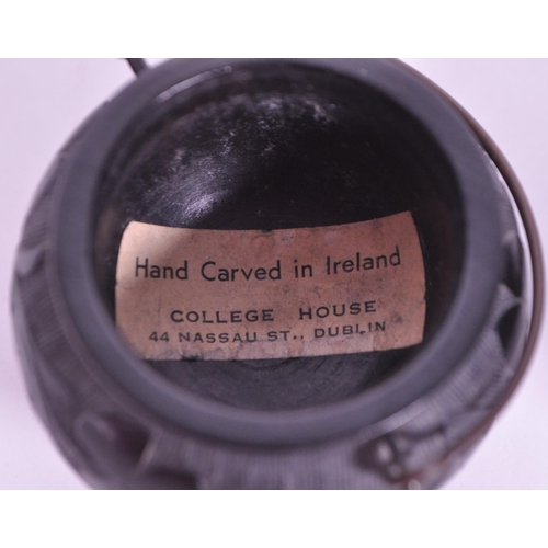 278 - Collection of four 20th century Irish carved ebony bog oak figures comprised of two cauldrons and tw... 