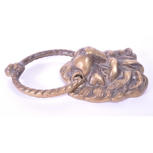 280 - A 19th century Victorian lion brass door knocker. Featuring a lion's head with ring knocker with ano... 