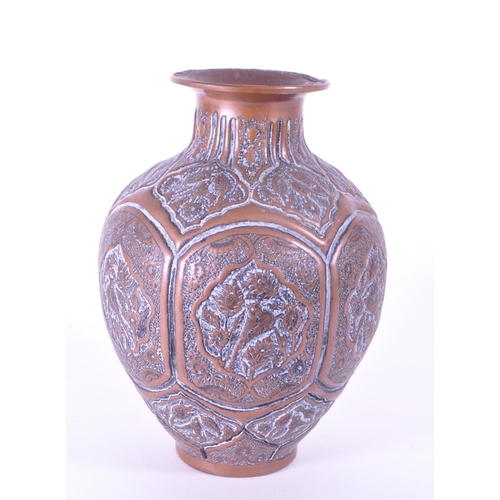 281 - North African early 20th century repousse copper vase. Flared rim into a bulbous body with bird figu... 