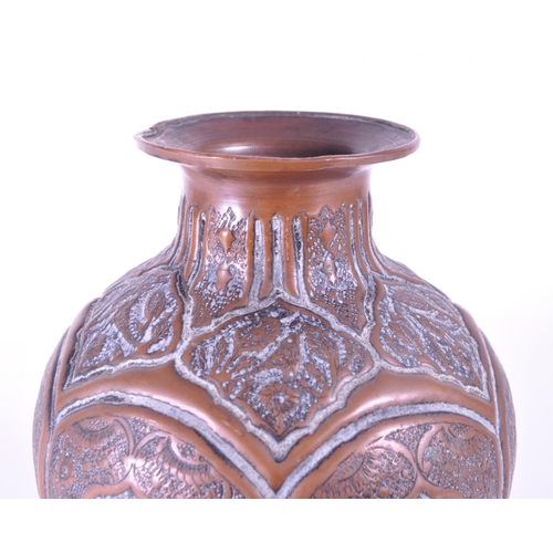 281 - North African early 20th century repousse copper vase. Flared rim into a bulbous body with bird figu... 