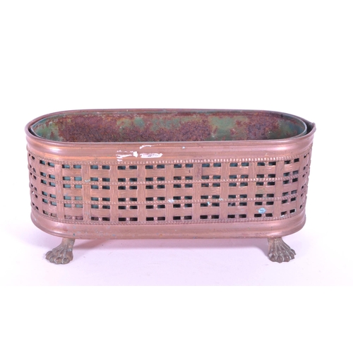 287 - A 19th century small copper planter pierced woven effect raised on lion paw feet. With a rusted meta... 