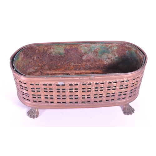 287 - A 19th century small copper planter pierced woven effect raised on lion paw feet. With a rusted meta... 