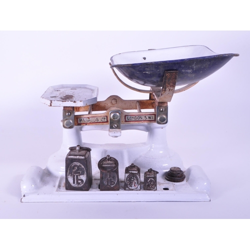 292 - Harrods Ltd - Early 20th century London cast iron weighing scales painted in a white enamel. Feature... 