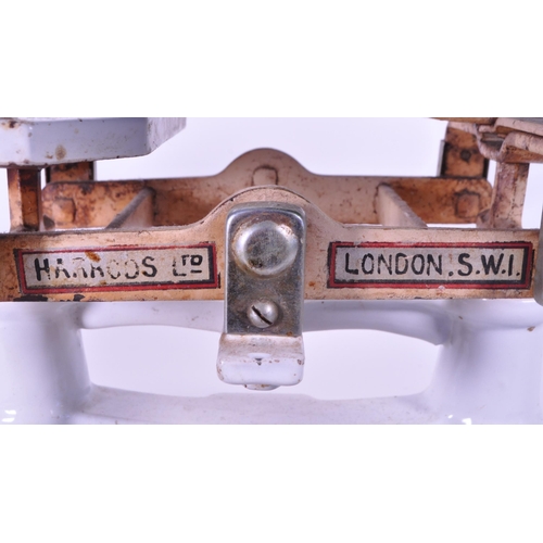 292 - Harrods Ltd - Early 20th century London cast iron weighing scales painted in a white enamel. Feature... 