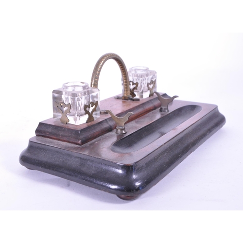 299 - An early 20th mahogany office desk tidy / ink well. With brass carry handle, two cut glass ink wells... 