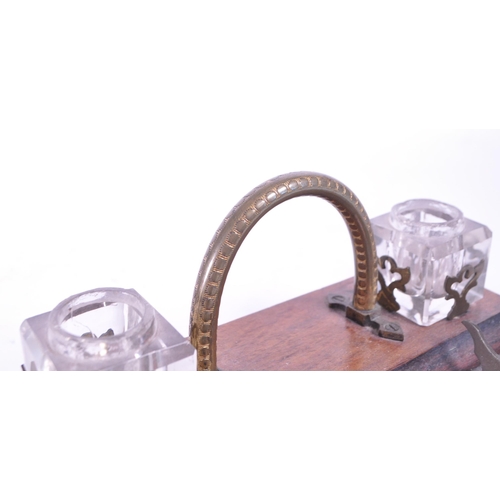 299 - An early 20th mahogany office desk tidy / ink well. With brass carry handle, two cut glass ink wells... 