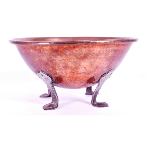 339 - A 19th century copper mixing bowl. Large hammered copper bowl on four wrought iron feet.(15cm x 30cm... 