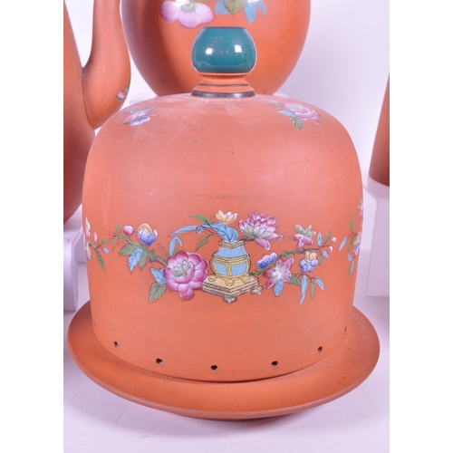 385 - A collection of 19th century Rosso Antico tableware items. To include cloche, water jugs, teapot, tw... 