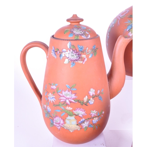 385 - A collection of 19th century Rosso Antico tableware items. To include cloche, water jugs, teapot, tw... 