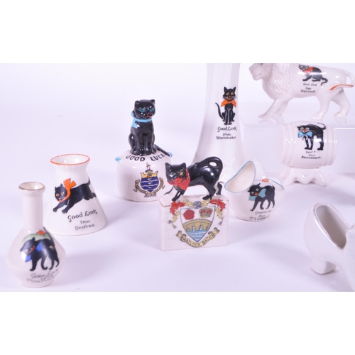 389 - Collection of early 20th century crested china porcelain figures, mostly including a Good Luck greet... 