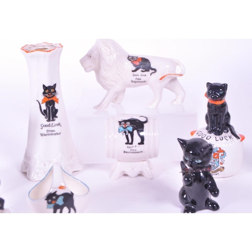 389 - Collection of early 20th century crested china porcelain figures, mostly including a Good Luck greet... 