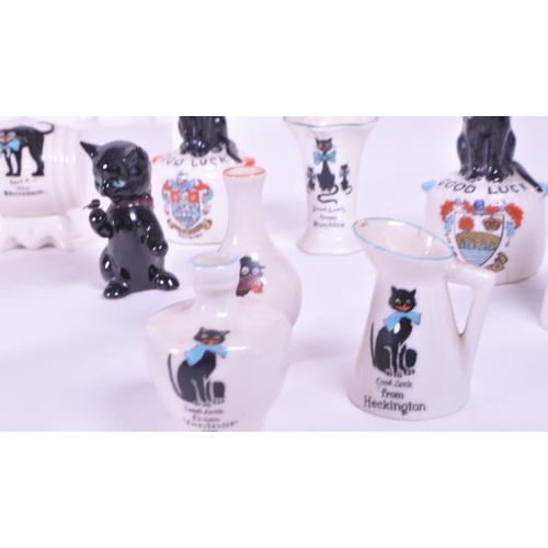 389 - Collection of early 20th century crested china porcelain figures, mostly including a Good Luck greet... 