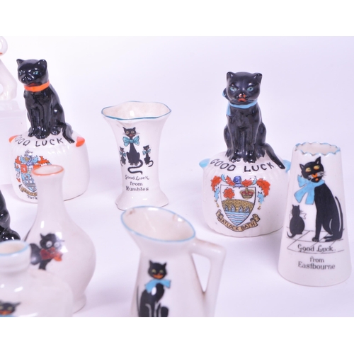 389 - Collection of early 20th century crested china porcelain figures, mostly including a Good Luck greet... 