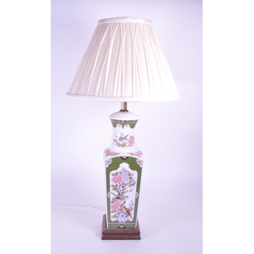 394 - A 20th century Chinese ceramic table lamp vase. Light fixing and shade to top, with garden pattern f... 