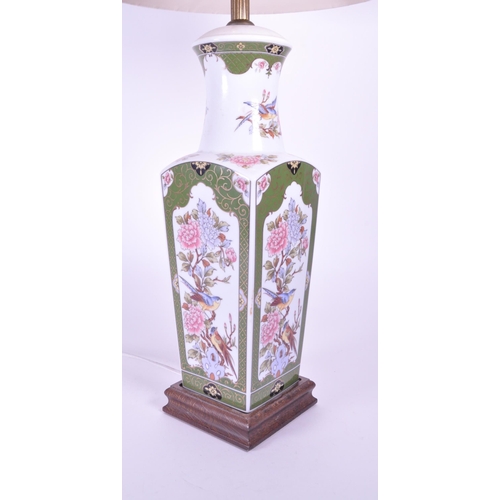 394 - A 20th century Chinese ceramic table lamp vase. Light fixing and shade to top, with garden pattern f... 