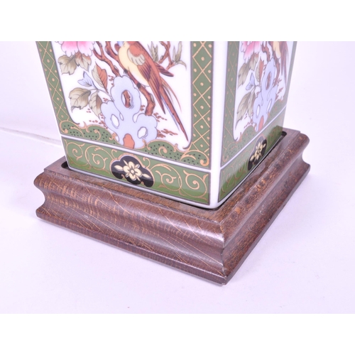 394 - A 20th century Chinese ceramic table lamp vase. Light fixing and shade to top, with garden pattern f... 