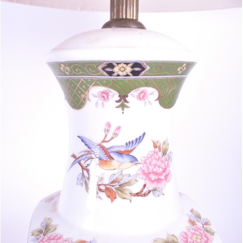 394 - A 20th century Chinese ceramic table lamp vase. Light fixing and shade to top, with garden pattern f... 