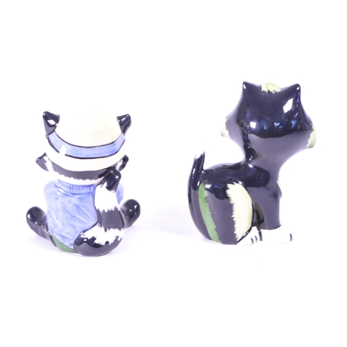 396 - Lorna Bailey (B. 1978) - Two contemporary art deco style ceramic cat figures. Comprised of a fisherm... 